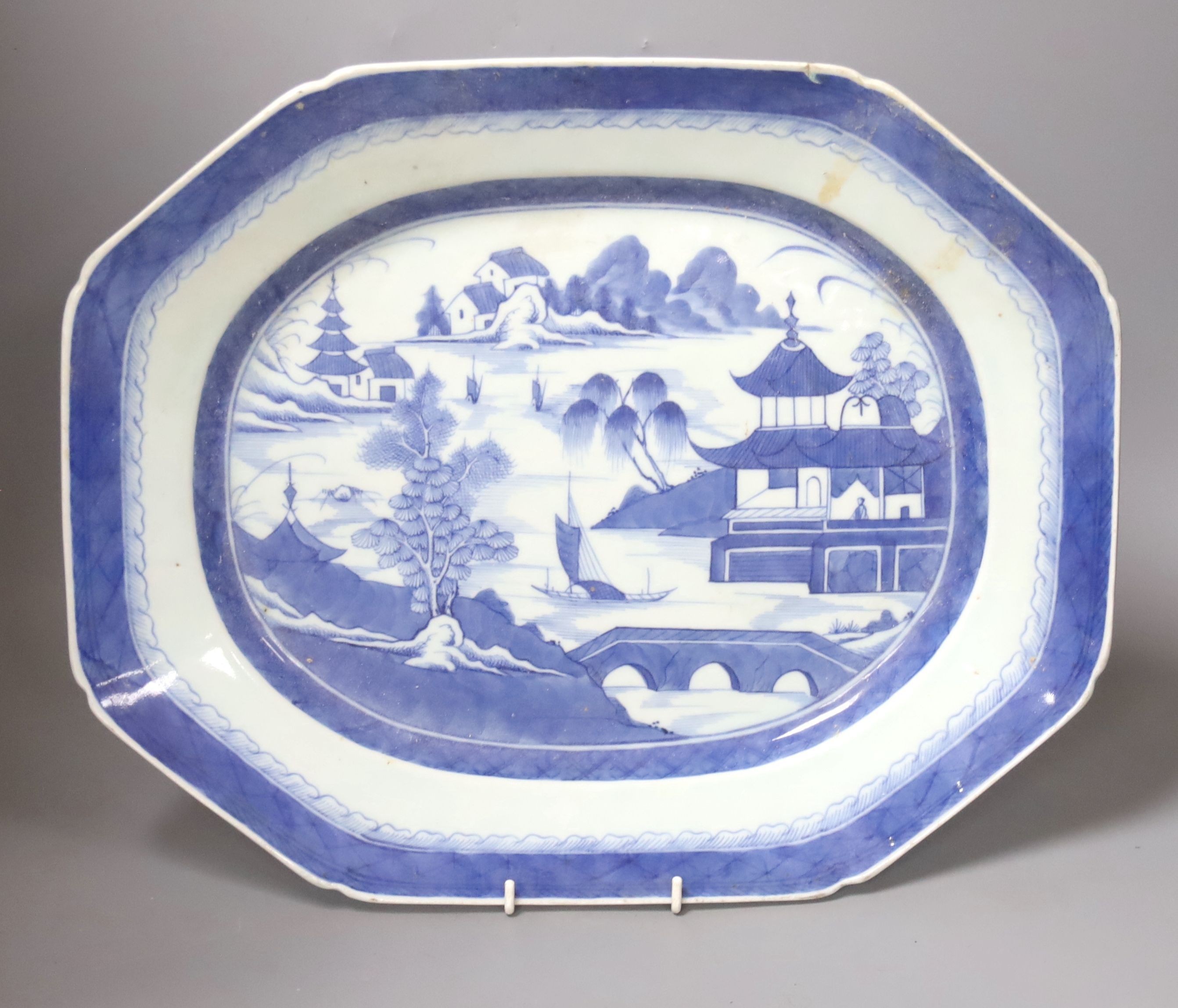 A 19th century Chinese Export blue and white octagonal meat dish, decorated with a lake scene, W 42cm
